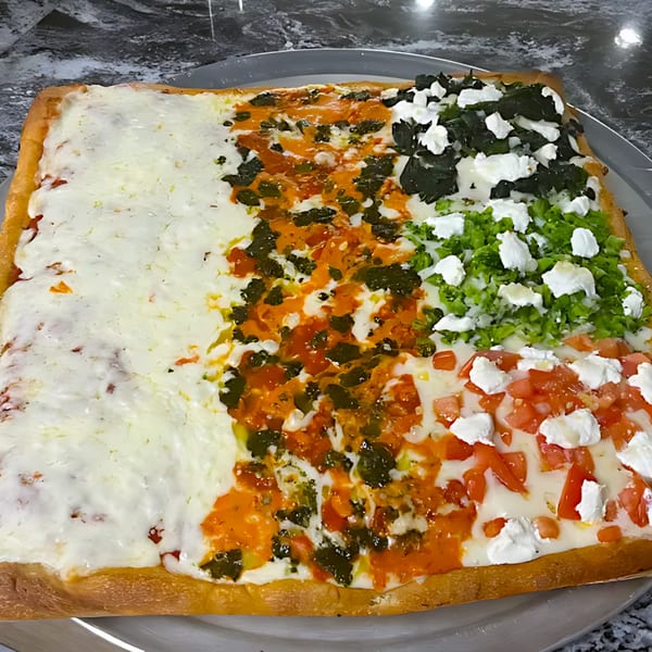 A large rectangular pizza from 2 Brothers Pizzeria with four distinct toppings, including plain cheese, pesto, spinach, and diced tomatoes.